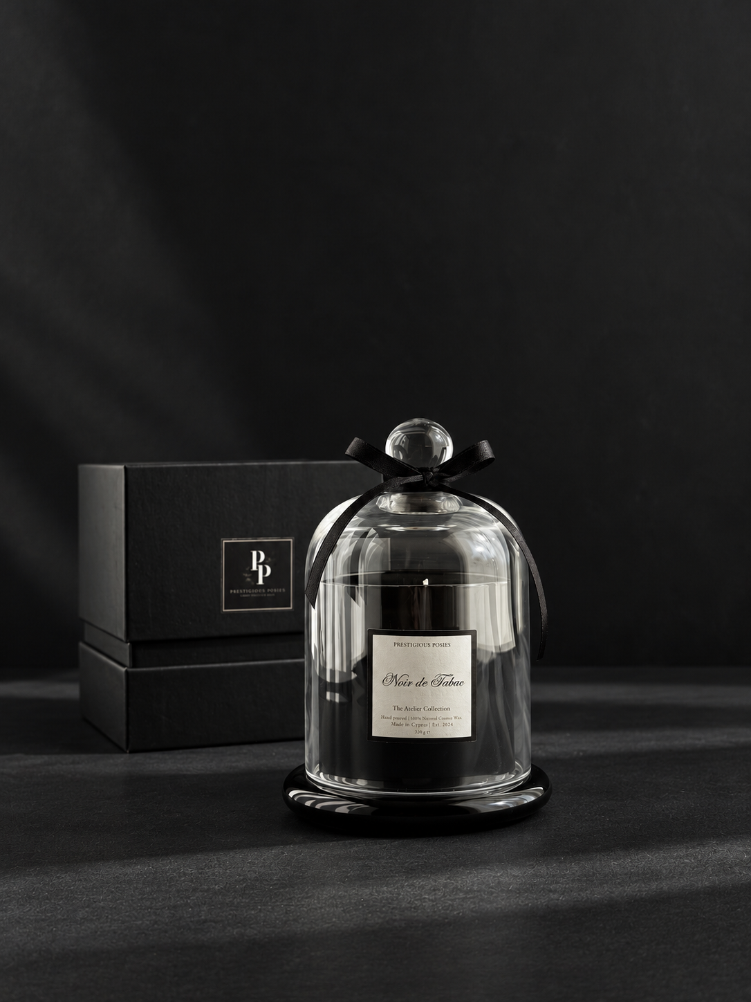The Cloche d'Élégance, a coco wax candle in a glossy black vessel beneath a clear glass cloche