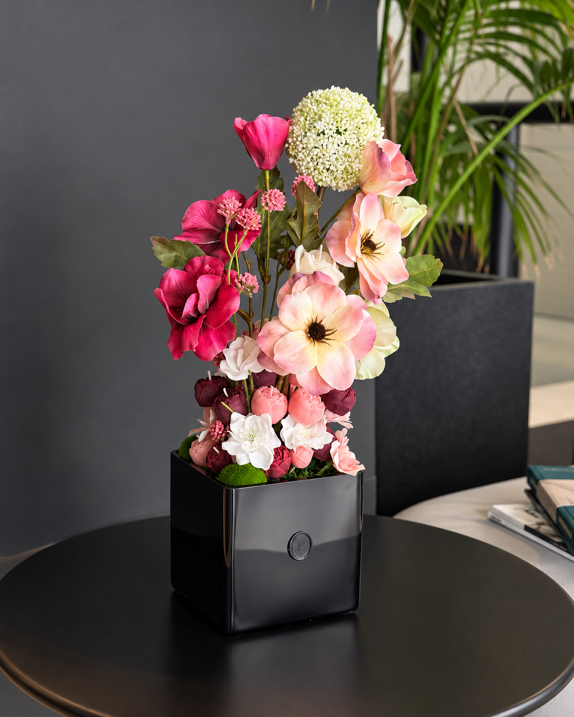 Belladonna, a tall candle bouquet of blush, ivory and burgundy olive wax flowers in a black square vase