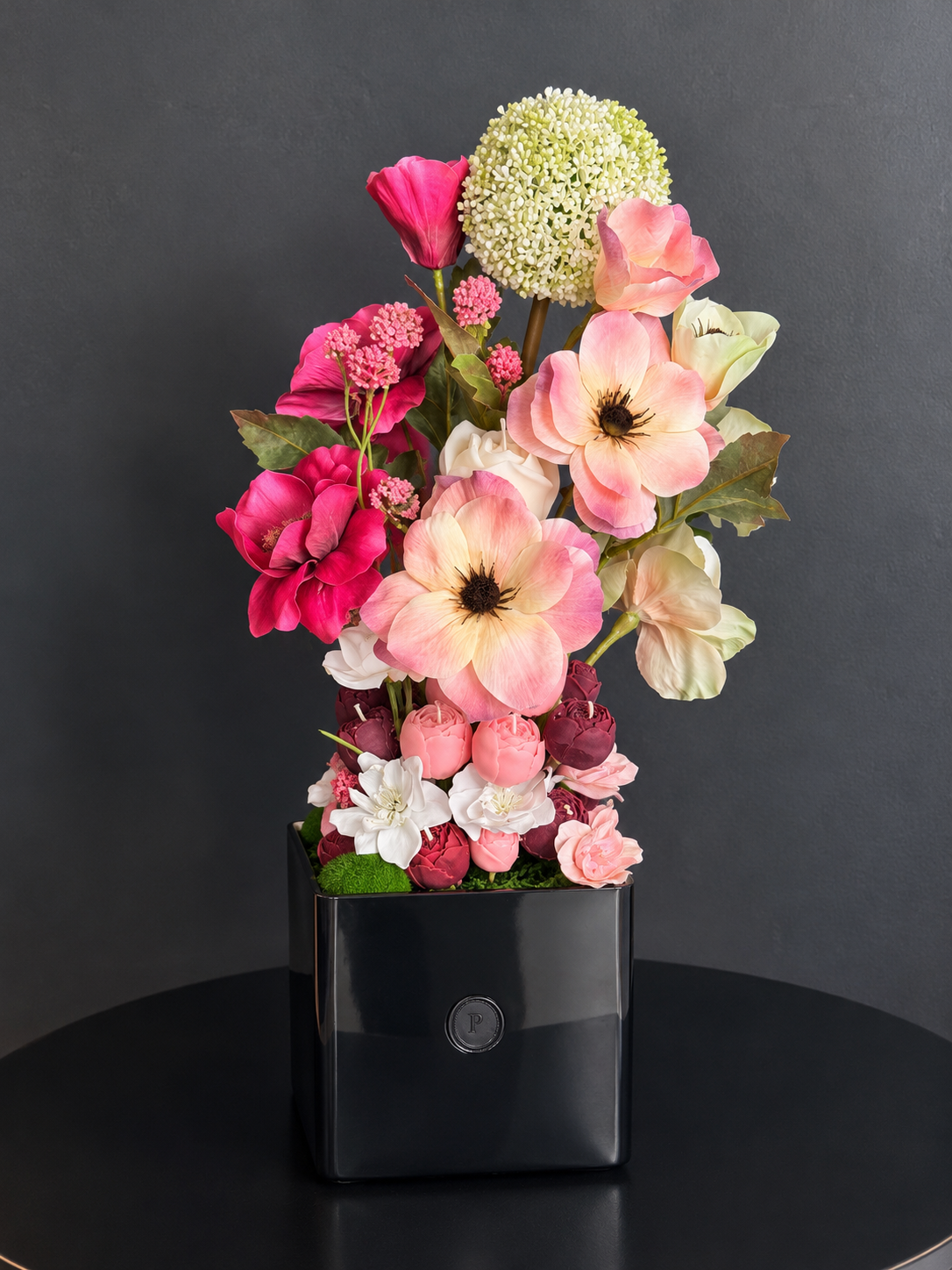 Belladonna, a tall candle bouquet of blush, ivory and burgundy olive wax flowers in a black square vase