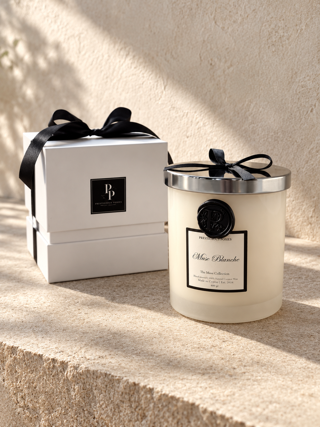 La Neige, a white frosted glass jar candle with a silver lid, by Prestigious Posies
