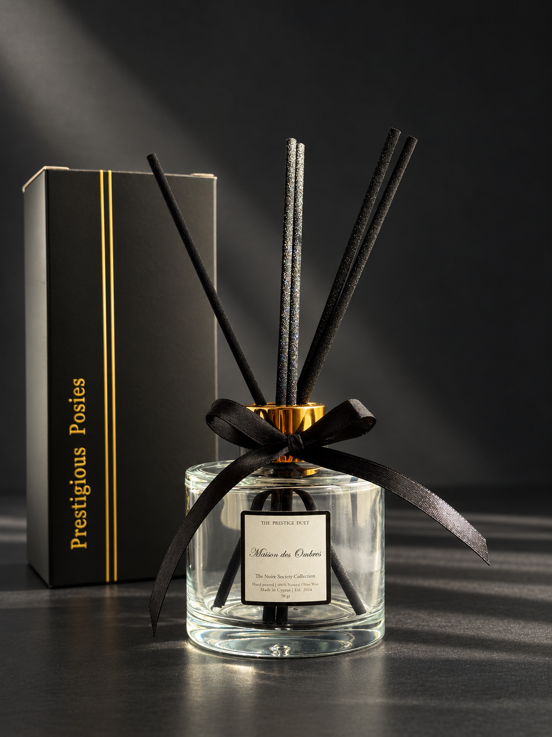 The Atelier Diffuser, a 100ml clear glass reed diffuser with black bamboo reeds, by Prestigious Posies