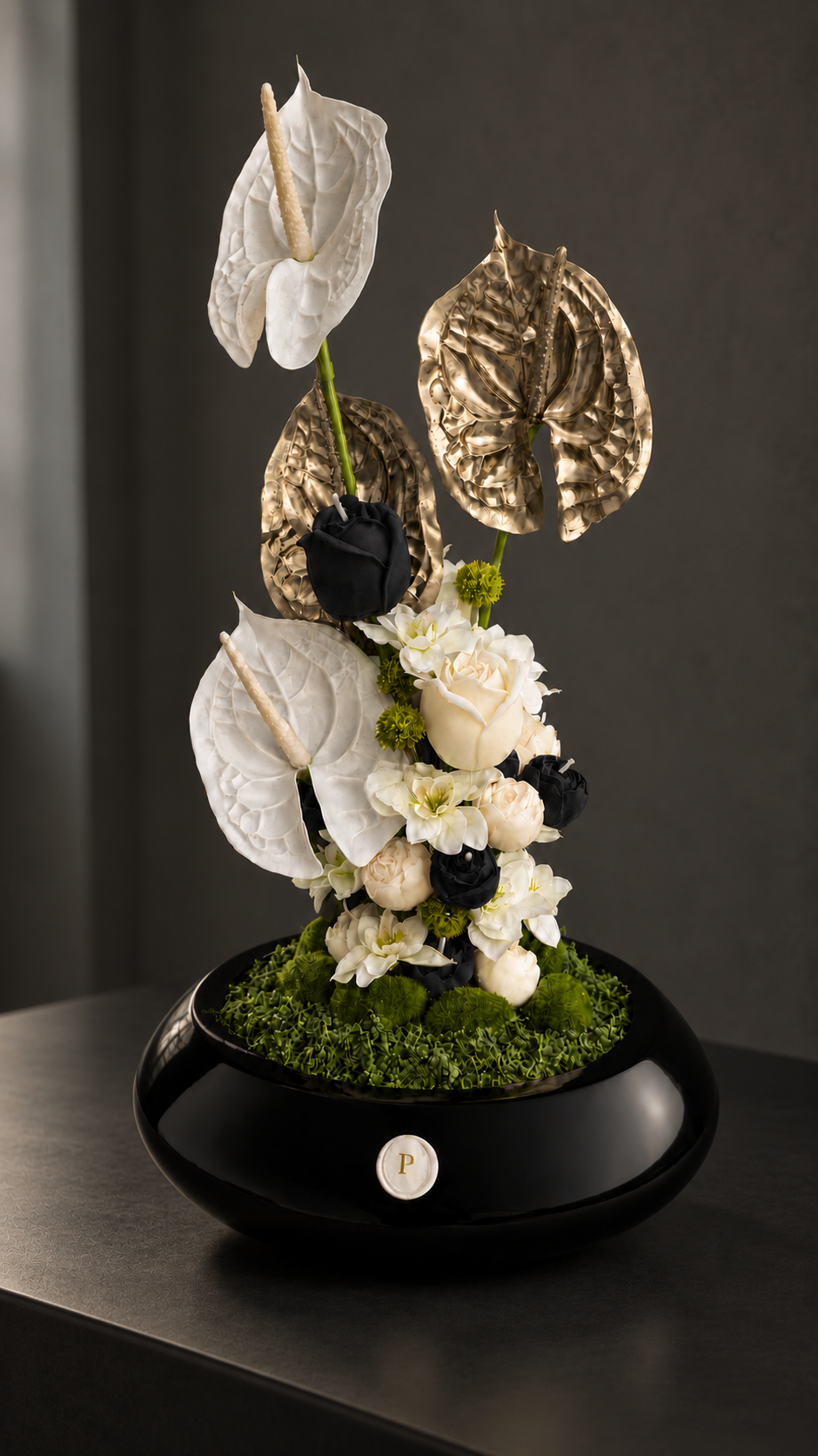 Amarante, a candle bouquet of burgundy, plum and ivory wax roses, anthuriums and orchids in a glossy black bowl