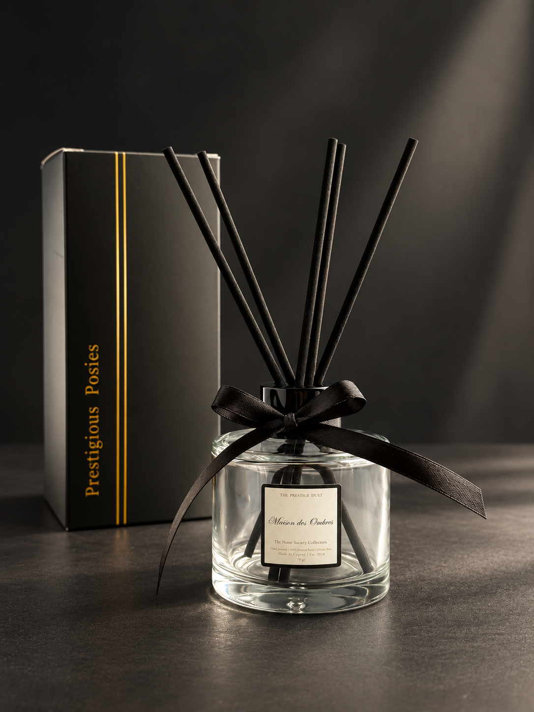 The Atelier Diffuser, a 100ml clear glass reed diffuser with black bamboo reeds, by Prestigious Posies
