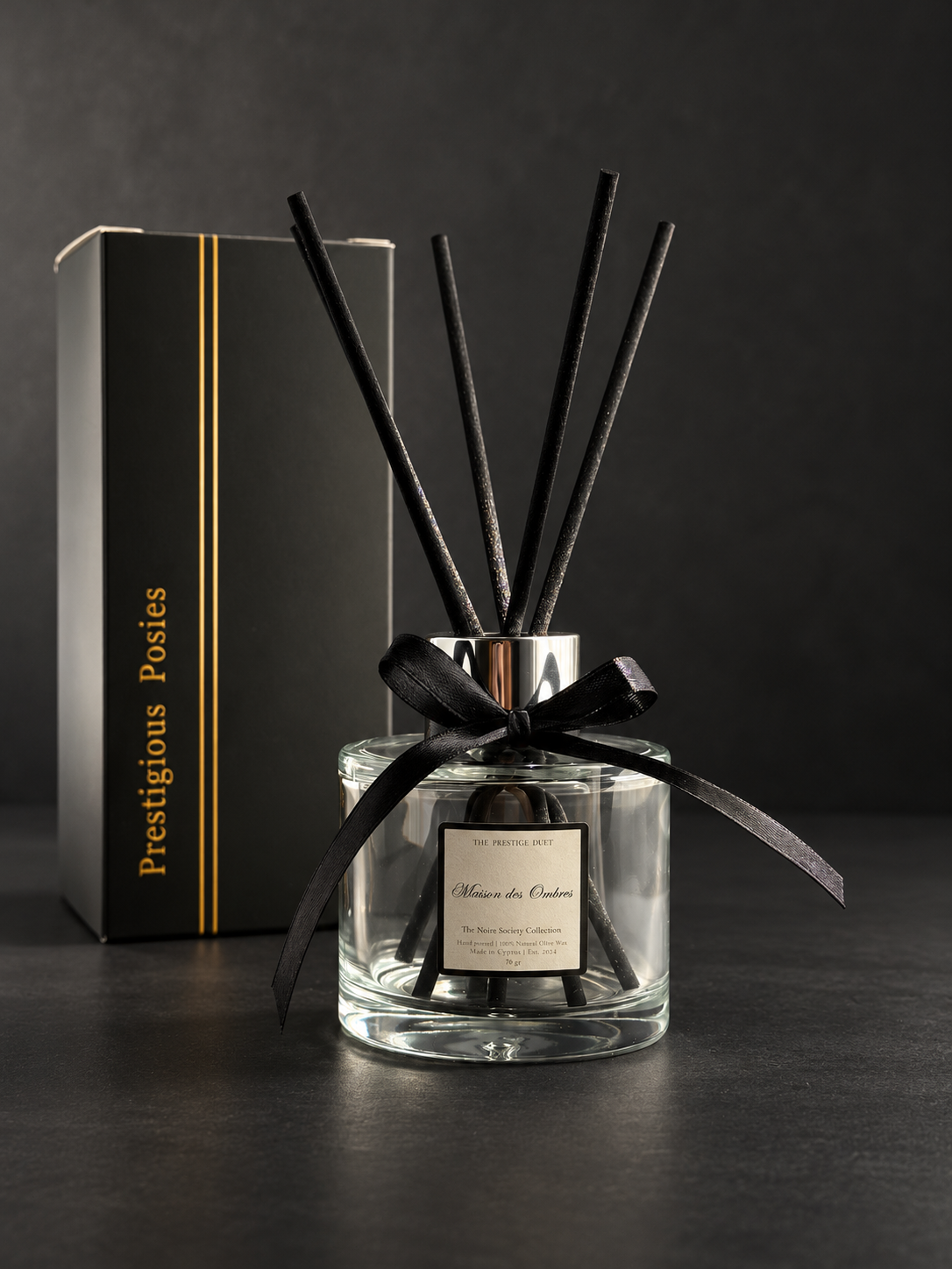 The Atelier Diffuser, a 100ml clear glass reed diffuser with black bamboo reeds, by Prestigious Posies
