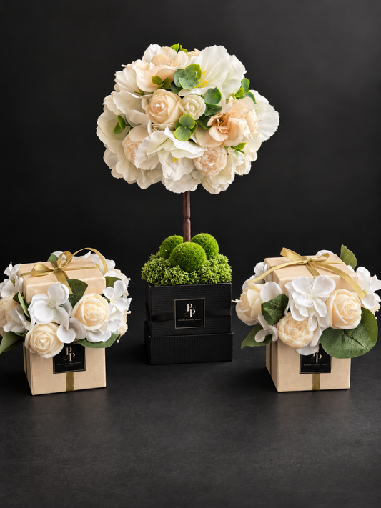 Fleur d'Amour, a rounded candle topiary of handcrafted olive wax flowers and greenery on a slender stem