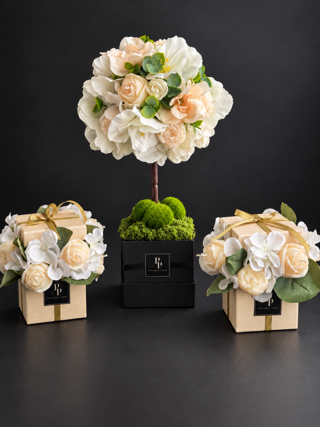 Fleur d'Amour, a rounded candle topiary of handcrafted olive wax flowers and greenery on a slender stem