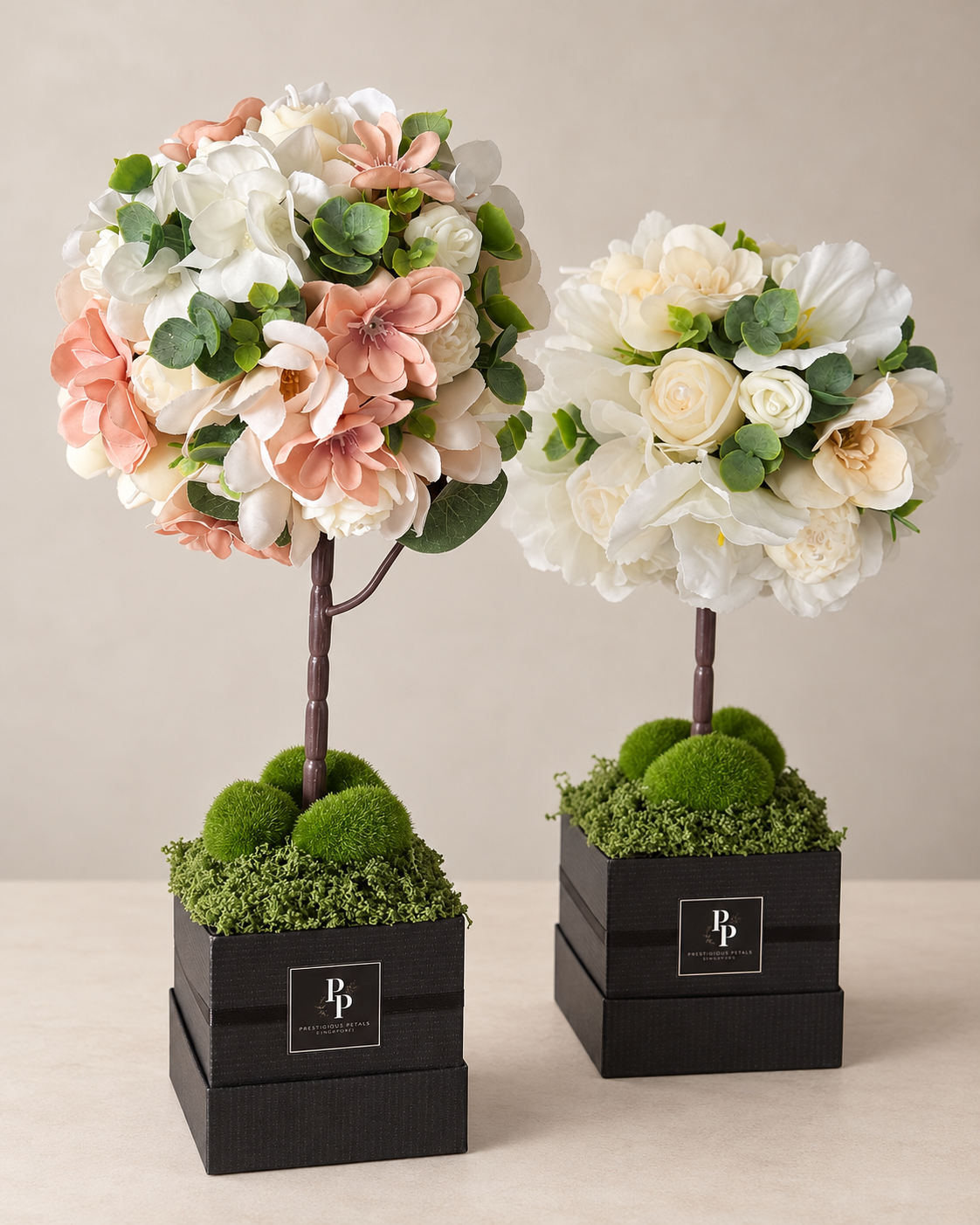 Fleur d'Amour, a rounded candle topiary of handcrafted olive wax flowers and greenery on a slender stem