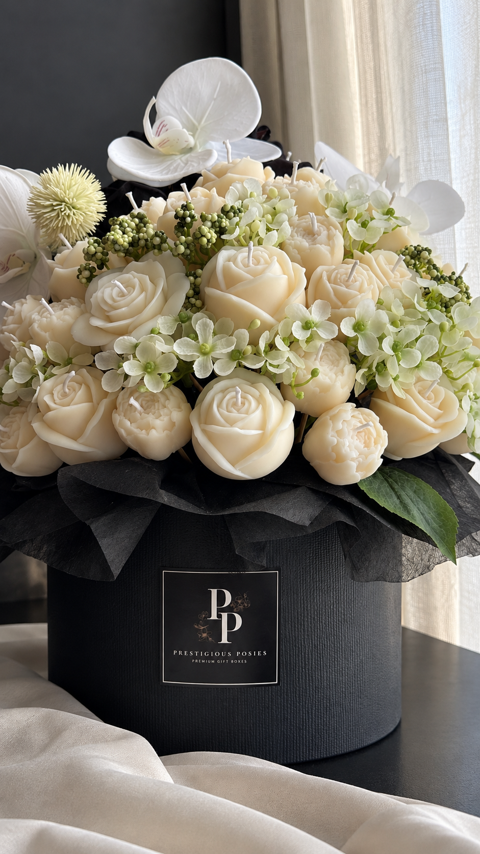 La Couronne Élitaire, a grand round olive wax candle flower bouquet in an elegant round box